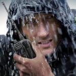 Portrait of adventure seeking hiker battling through heavy rain.